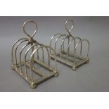 A pair of silver five bar toastracks, each of rectangular form,