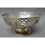 A silver bowl of circular form, with pierced and cast scroll and foliate swag decoration,