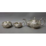 A three piece tea set, comprising; a teapot, a sugar bowl and a milk jug,