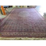 A machine made carpet of Persian design.