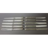 Ten silver handled fruit or dessert knives, having plated blades, the loaded handles London 1913,