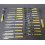 Twelve silver bladed fish knives, with ivory handles and twelve silver fish forks,