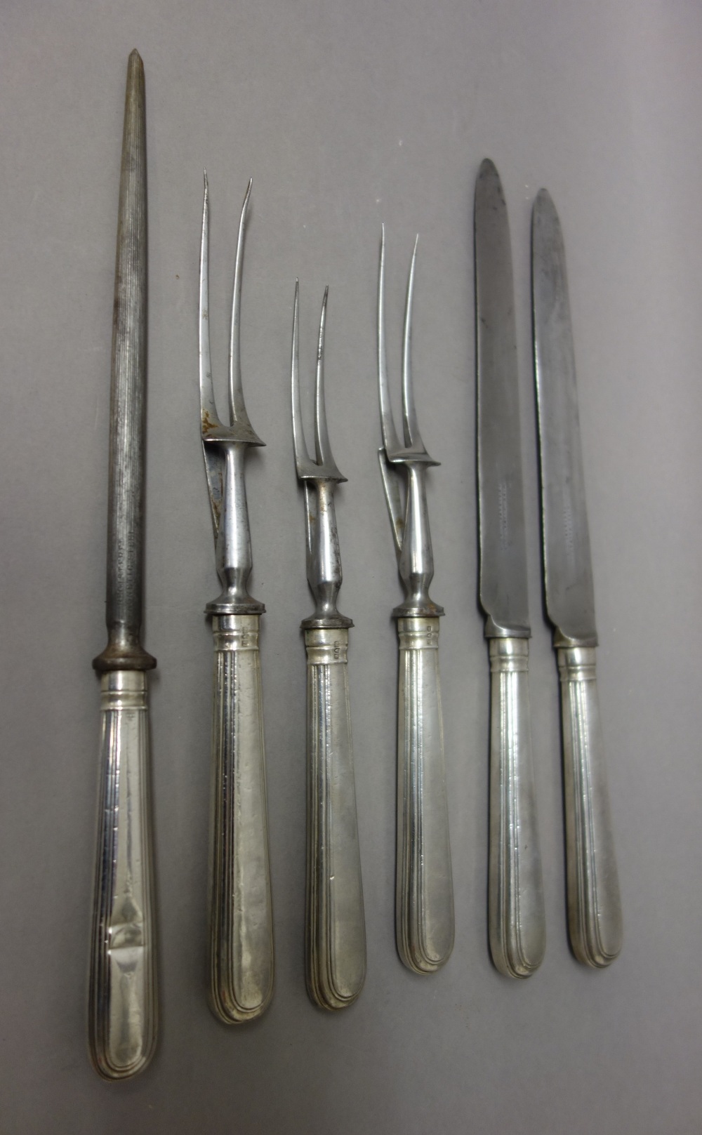 A silver handled five piece carving set, comprising; two carving knives,