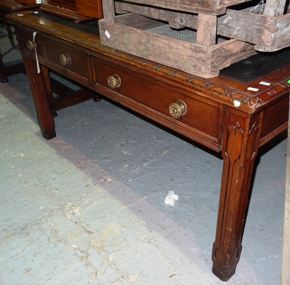 A Gothic Revival mahogany and walnut writing desk, on square block supports, 150cm wide x 78cm high.