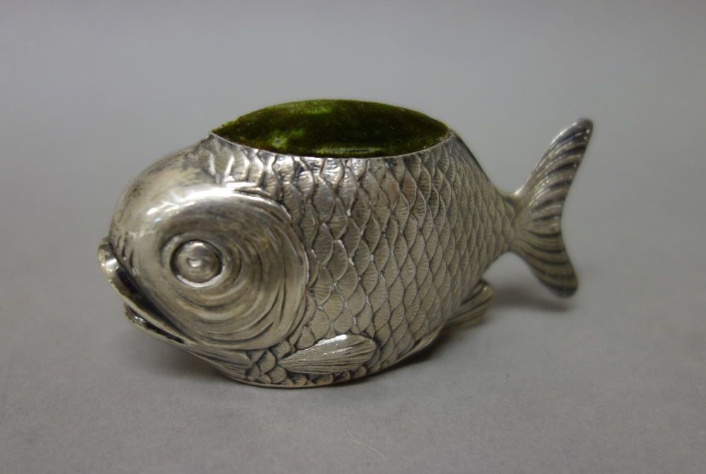 A silver novelty pin cushion, designed as a fish, length 9cm, Chester possibly 1908, maker S.