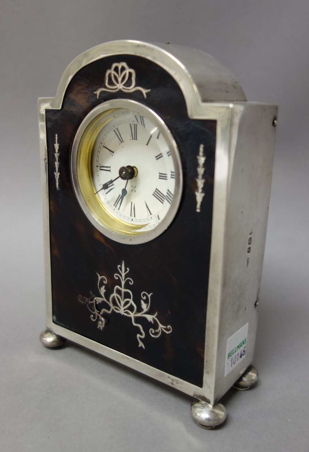 A silver and tortoiseshell mounted rear winding mantel clock,