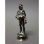 A late Victorian silver seal, modelled as the standing figure of a street vendor, monogram engraved,