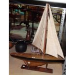 A 20th century model of a pond yacht and stand.