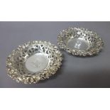 A pair of Sterling bonbon dishes, each with scroll pierced decoration within a floral moulded rim,