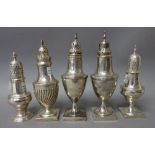 A group of five silver sugar and spice casters, in a variety of baluster and urn shaped designs,