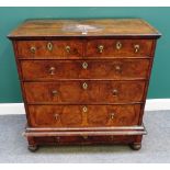 An early 18th century feather banded figured walnut chest on stand,