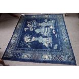 A Chinese rug, early 20th century, the blue field with vases and jardiniere in a foliate border,
