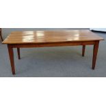 A 19th century French cherry wood extending dining table, the plank top on tapering square supports,