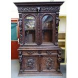 A 19th century German extensively carved oak display cabinet cupboard,