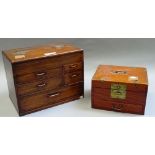 A 19th century Eastern softwood table cabinet, the lift top over five various drawers,