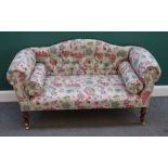 A modern hump back sofa, of small proportions, with floral upholstery,