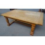 A 17th century style oak dining table, the cleated plank top on four turned supports,