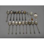 Mostly silver, comprising; a caddy spoon, with a paste set thistle terminal to the handle,
