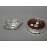 A silver twin handled bonbon dish of circular form,