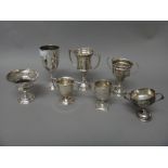 A group of seven silver trophy cups, (note: one with lead melted into the base),