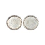 A pair of George III Irish silver salvers, each of circular form,