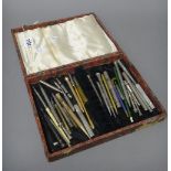 A collection of silver, gold plated, base metal and other writing implements, mostly pencils,