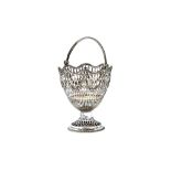 A George III silver sugar basket, with pierced decoration, above a fluted band,