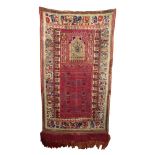 An Indian prayer rug, 19th century, the mirab decorated with a temple flanked by columns,