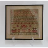 A needlework sampler worked with alphabets and numerals,