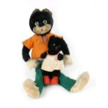 A Schuco bigo-bello black cat dressed in an orange jumper and green trousers, 36cm,