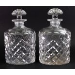 A pair of Tudor glass spirits decanters, with mushroom stoppers and facet and diamond cut sides,
