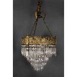 A Regency style chandelier, 19th century, the ormolu gallery decorated with cherubs,