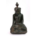 A South East Asian carved and painted wood figure, of a seated Buddha with stopper in head,