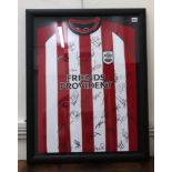 A signed Southampton Football club shirt, signed by various team members, framed,