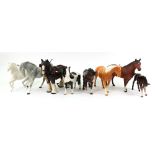 A collection of seven Beswick horses, the largest 20cm high, and a Melba ware shire horse (8).