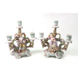 A pair of Sitzendorf porcelain three light candelabrum, encrusted with flowers,