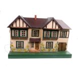 A vintage Tri-ang dolls house, in the form of a half timbered gabled residence,