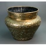 A large Middle Eastern brass jardiniere, variously decorated with animals,