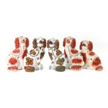 A pair of Staffordshire pottery spaniels, late 19th century, each seated,