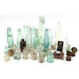A collection of glass bottles, glass inkwells, pottery inkwell,