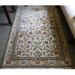 A Thai Fleurs pattern rug, on an ivory ground,