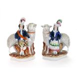 A pair of Staffordshire highland figures standing before frit decorated sheep, 20.