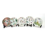 A group of five Chinese famille-rose saucers, 19th century, variously painted with flowers,