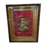 A Victorian style gilt metal half block plaque, depicting a bust of a King Charles Cavalier,