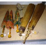 A group of three hand painted parasols and two further larger with gilt painted tops and cotton