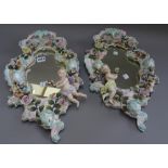 A pair of Sitzendorf wall mirrors, late 19th century, of rococo form,