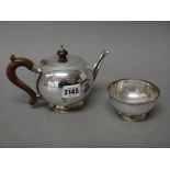 A silver bullet shaped teapot, in an early 18th century design, with brown composition fittings,