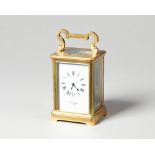 A French brass carriage clock Circa 1910 In a corniche case with looped handle,