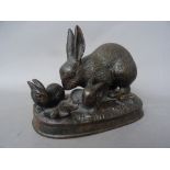 A 20th century patinated bronze rabbit group, modelled on a naturalistic shaped base, 16cm wide.