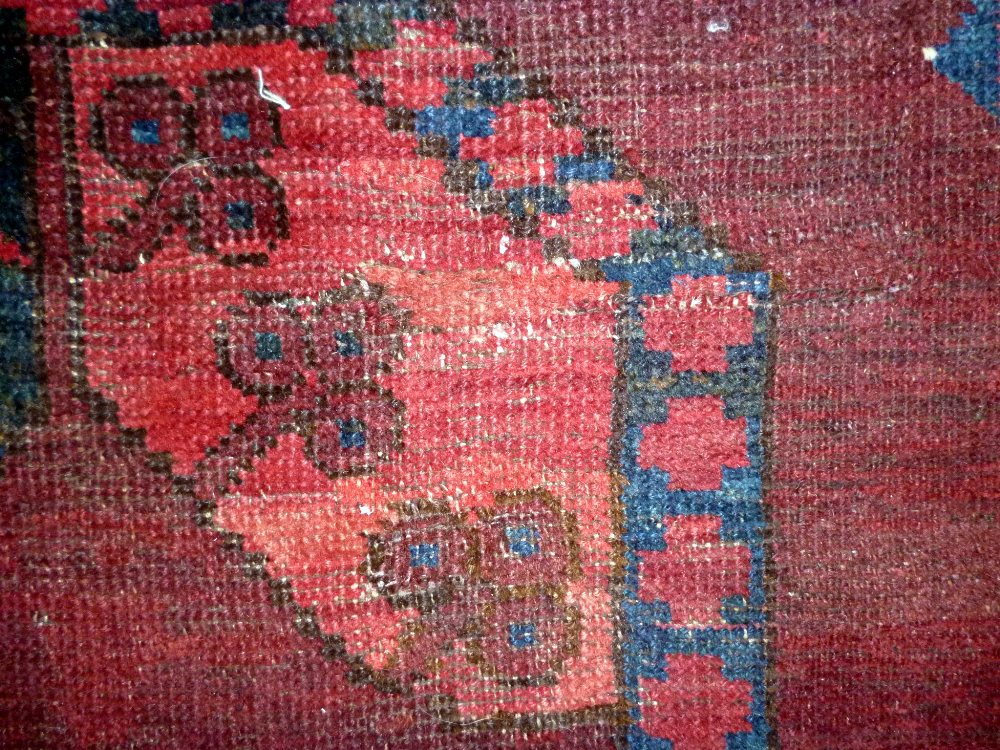 An Afghan Esari carpet, the dark madder field with three columns of six bold guls, - Image 12 of 12